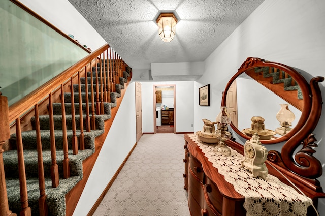 interior space featuring carpet and a textured ceiling