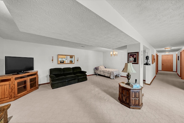 bedroom with a textured ceiling, light carpet, and a chandelier