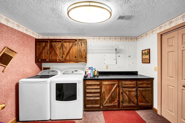 clothes washing area with carpet, cabinets, a textured ceiling, and independent washer and dryer