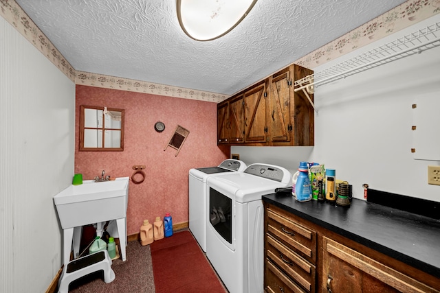 laundry room with cabinets, a textured ceiling, separate washer and dryer, and dark carpet