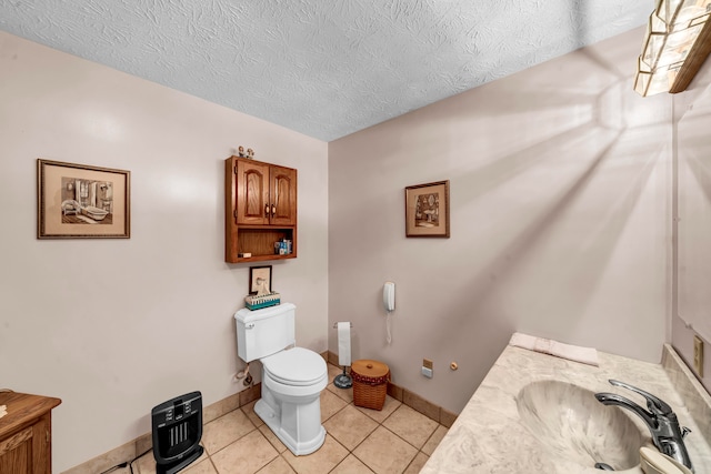 bathroom featuring tile patterned floors, vanity, a textured ceiling, and toilet