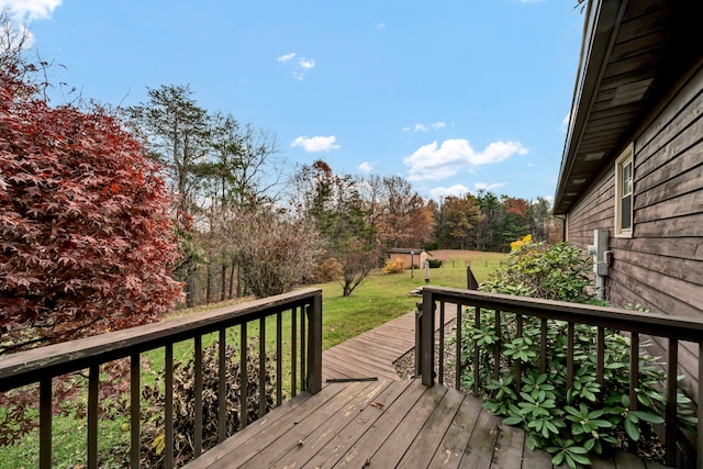 wooden terrace featuring a yard