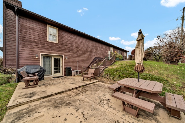 back of house with a yard and a patio