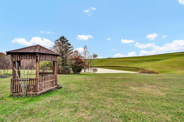 view of yard featuring a gazebo and a water view