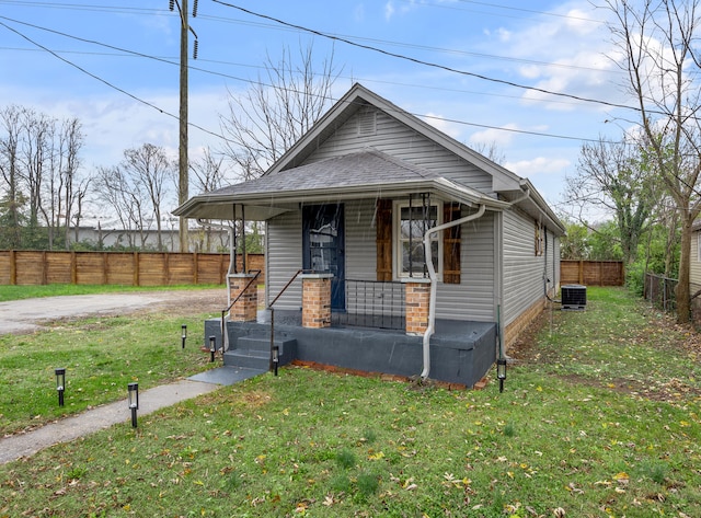 bungalow-style home featuring a porch, central air condition unit, and a front yard