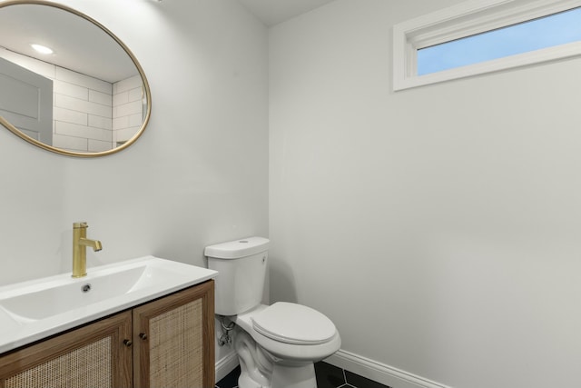 bathroom with tile patterned flooring, vanity, and toilet