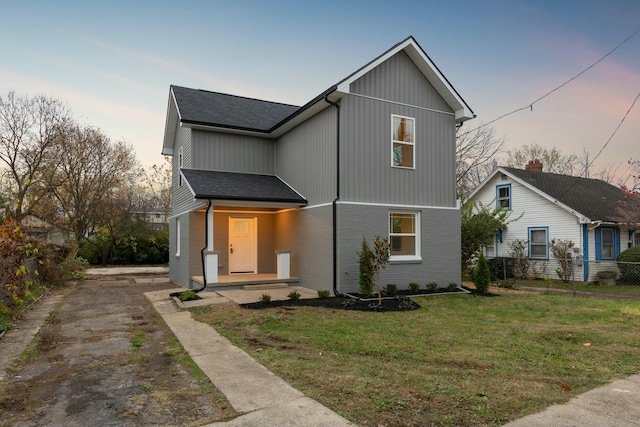 view of front of property with a yard