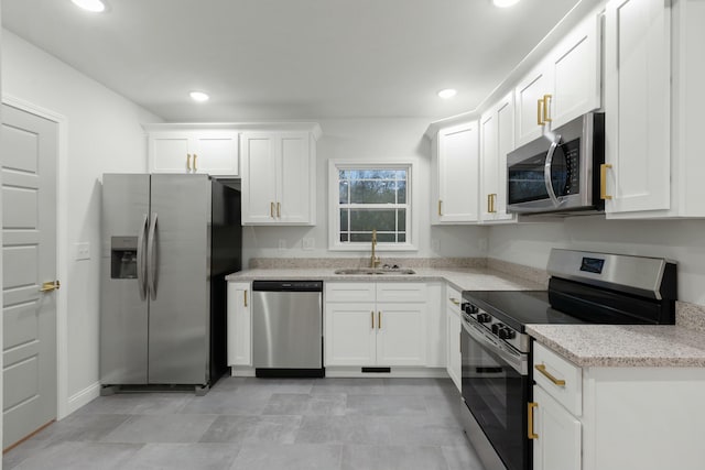 kitchen featuring white cabinetry, sink, and appliances with stainless steel finishes