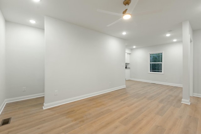 spare room with ceiling fan and light wood-type flooring