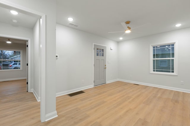 empty room with ceiling fan and light wood-type flooring