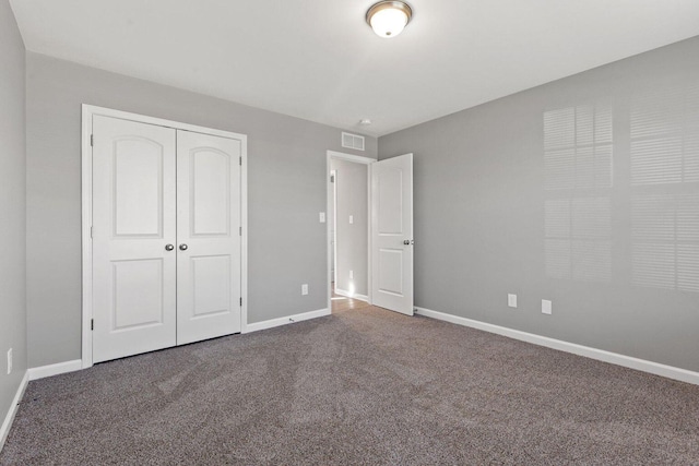 unfurnished bedroom featuring carpet floors and a closet