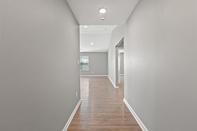 hallway with light hardwood / wood-style floors