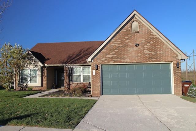 view of front of house featuring a front lawn and a garage