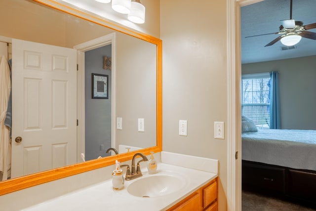 bathroom featuring a textured ceiling, vanity, and ceiling fan