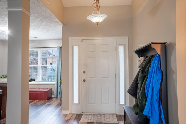 entrance foyer with hardwood / wood-style floors and a textured ceiling