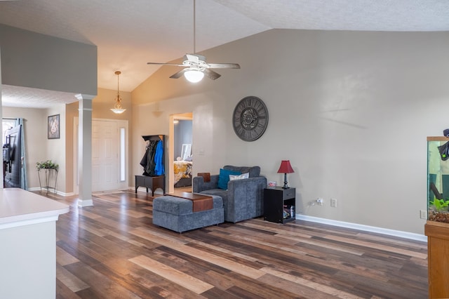 living room featuring ornate columns, ceiling fan, dark hardwood / wood-style flooring, high vaulted ceiling, and a textured ceiling