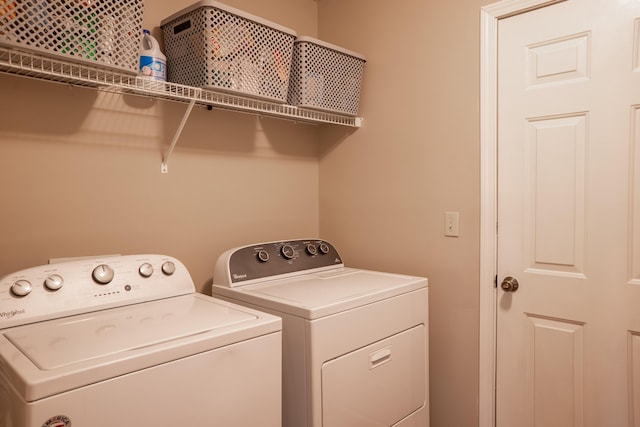 clothes washing area featuring separate washer and dryer