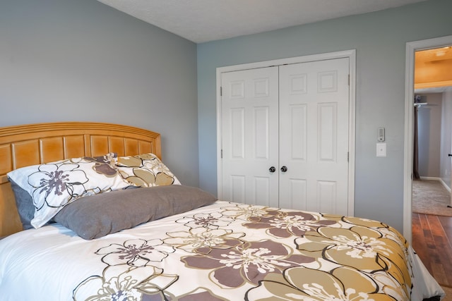 bedroom featuring a closet, hardwood / wood-style floors, and a textured ceiling