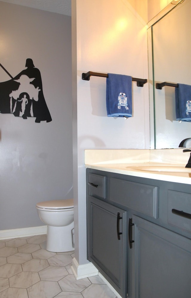 bathroom featuring tile patterned floors, vanity, and toilet