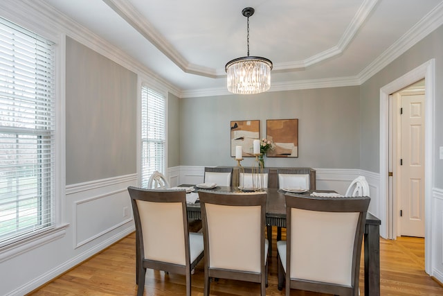 dining room featuring crown molding, a chandelier, and light wood-type flooring