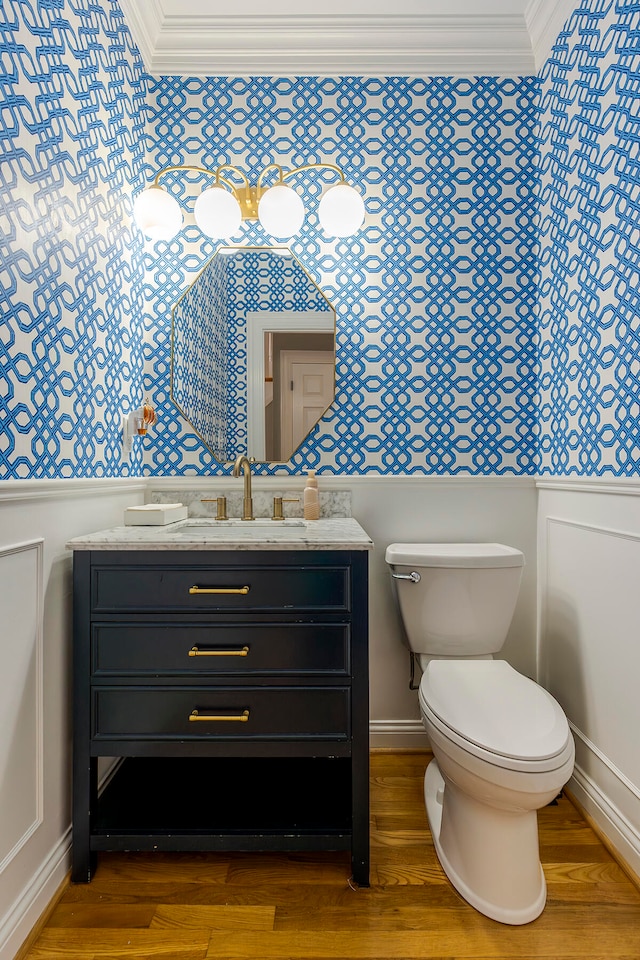 bathroom with crown molding, vanity, and wood-type flooring