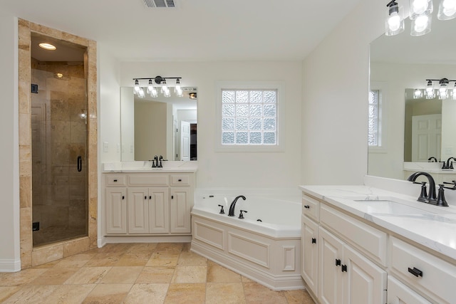 bathroom with vanity and separate shower and tub