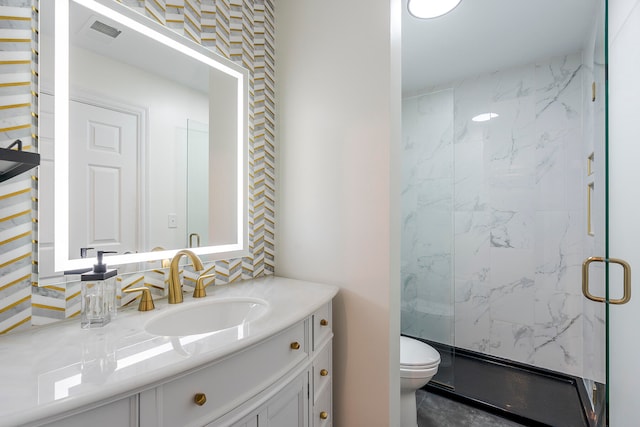 bathroom with vanity, an enclosed shower, and toilet