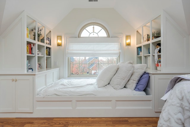 bedroom featuring hardwood / wood-style floors and lofted ceiling