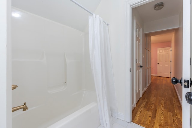 bathroom featuring hardwood / wood-style floors and shower / bath combo