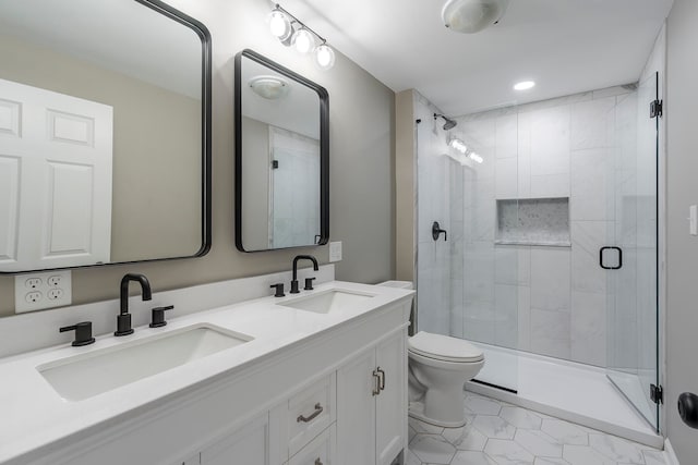 bathroom featuring toilet, vanity, tile patterned floors, and a shower with shower door