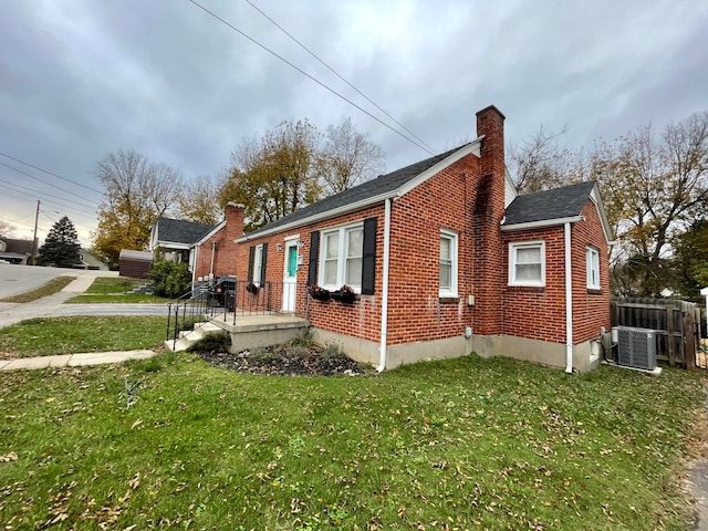 view of home's exterior with central air condition unit and a lawn