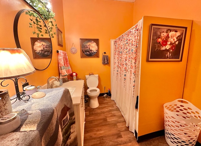 bathroom with a shower with curtain, vanity, toilet, and wood-type flooring