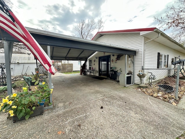 view of side of home with a carport