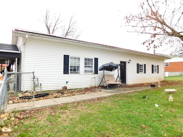 rear view of property featuring a yard