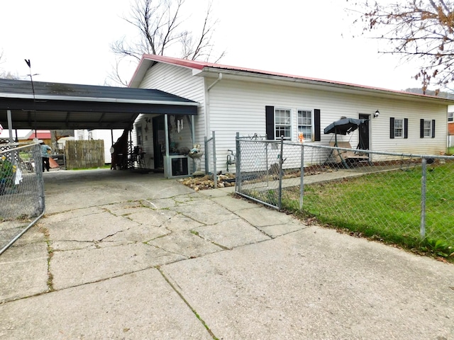 view of front facade with cooling unit and a carport