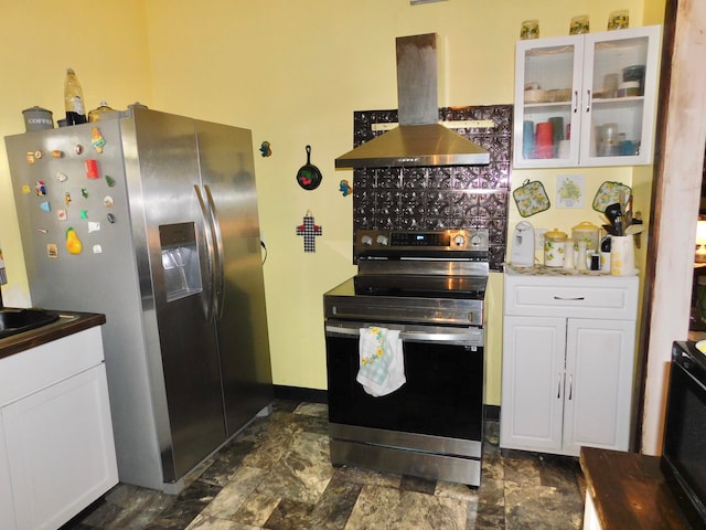 kitchen with island exhaust hood, appliances with stainless steel finishes, and white cabinets