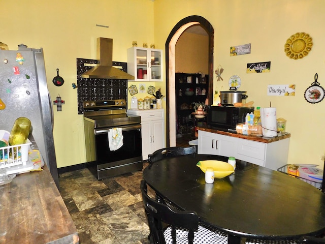 kitchen featuring stainless steel fridge, exhaust hood, white cabinetry, and electric stove