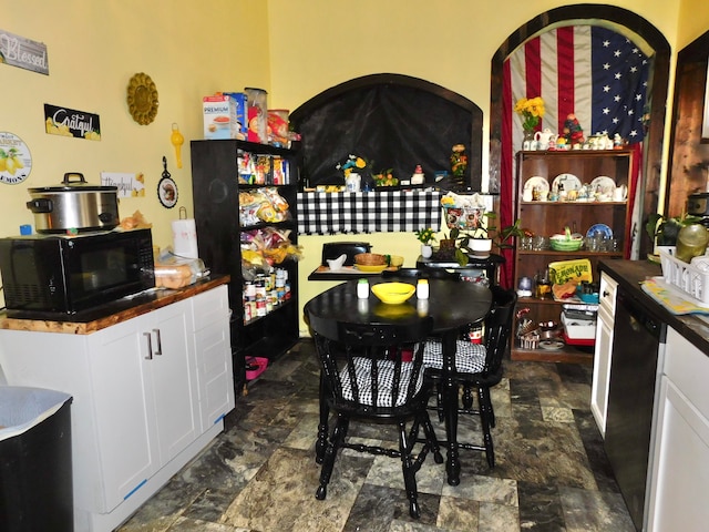 kitchen with black appliances and white cabinetry