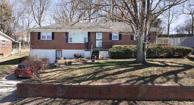 ranch-style house featuring brick siding, a front lawn, and fence