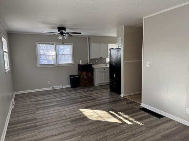 corridor featuring carpet flooring and a textured ceiling