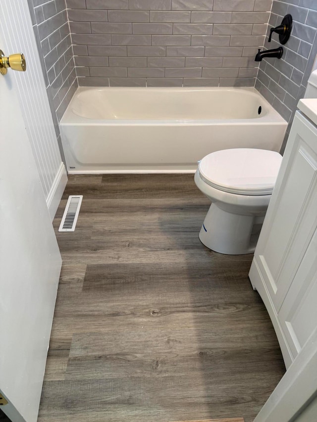 full bathroom featuring vanity, toilet, and tiled shower / bath