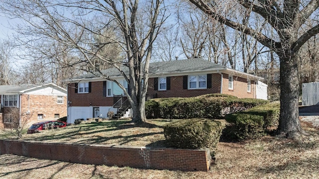 single story home featuring brick siding and a front lawn