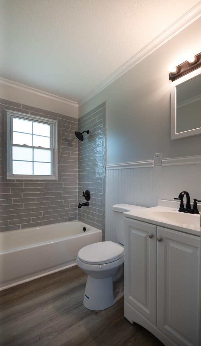 bathroom with vanity, wood finished floors, ornamental molding, bathtub / shower combination, and toilet