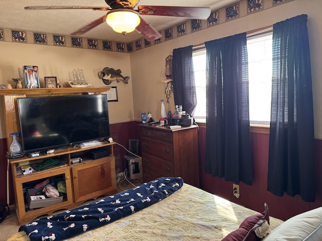 bedroom with a textured ceiling and a ceiling fan