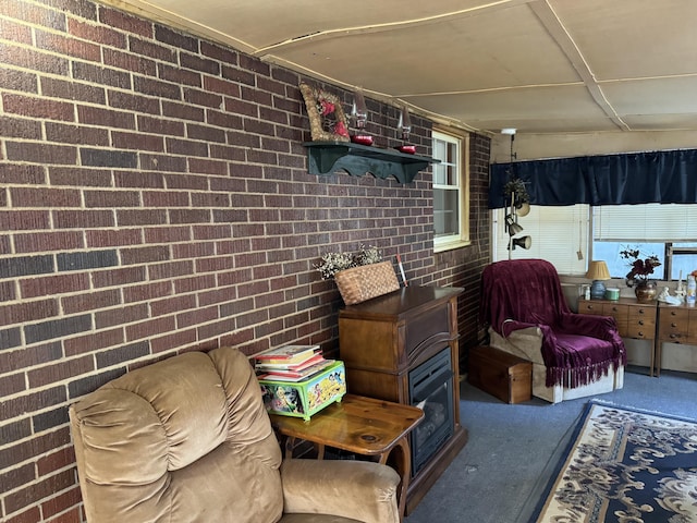 interior space featuring brick wall and carpet floors