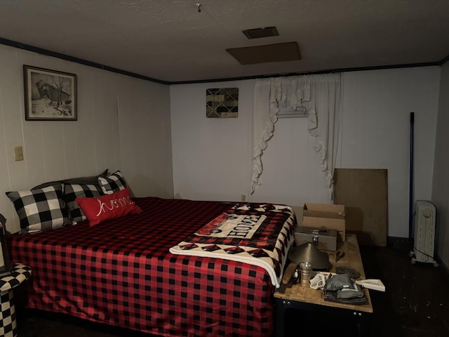 bedroom featuring crown molding and radiator heating unit