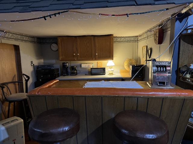 kitchen with a breakfast bar and tile counters