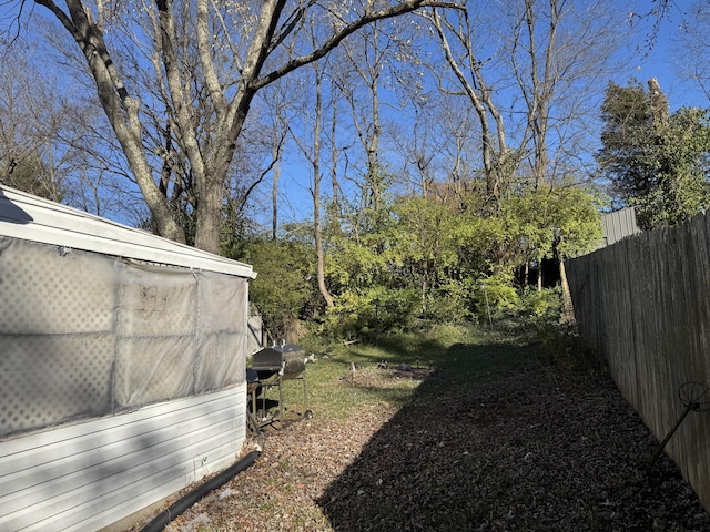 view of yard featuring an outbuilding and fence