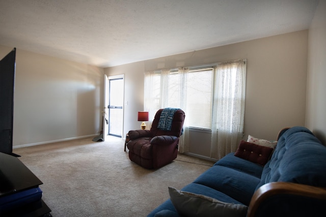 carpeted living room with baseboards