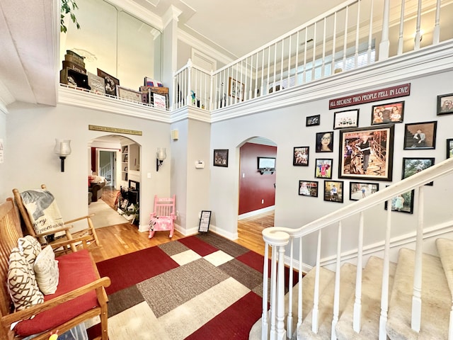 interior space with wood-type flooring and a high ceiling